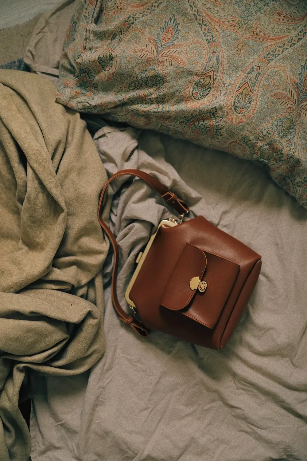Leather bag in natural light on a textured bedspread