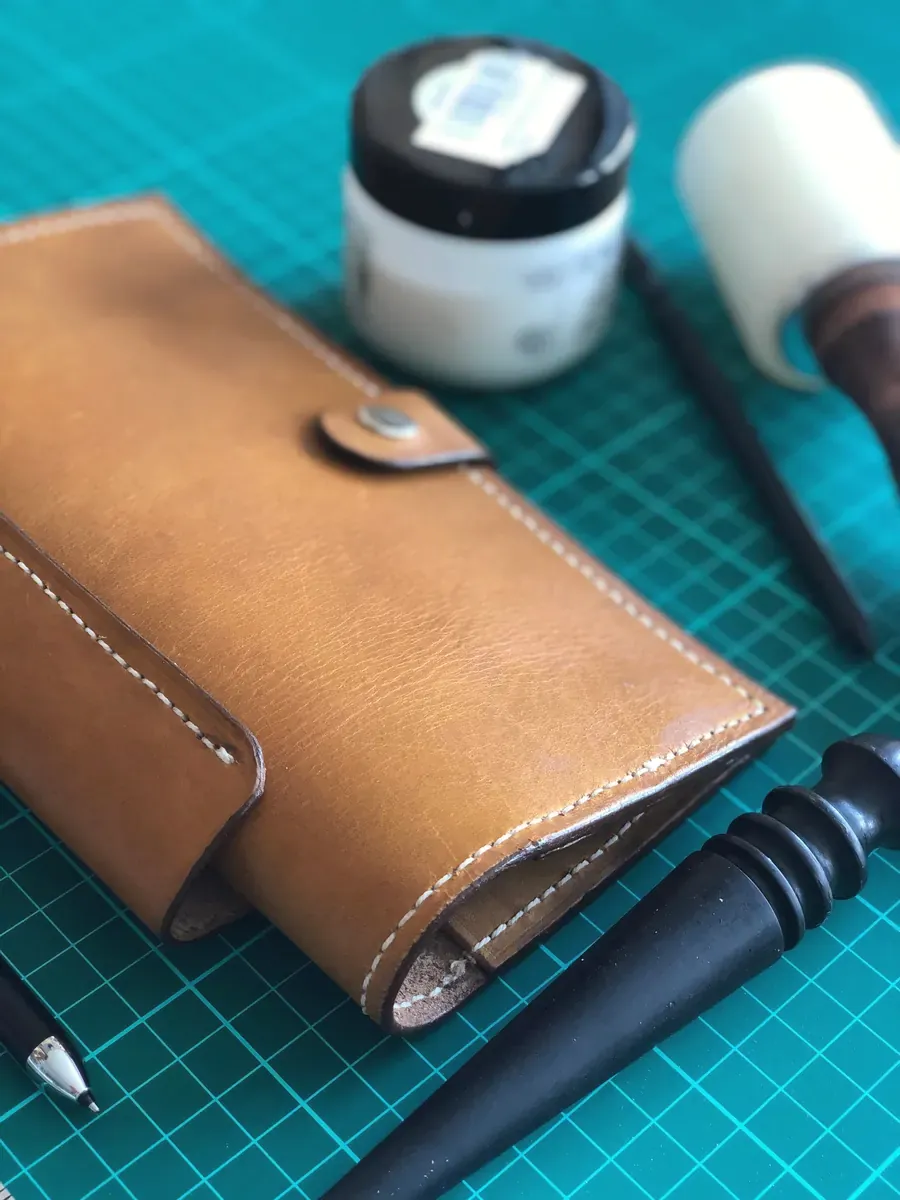 Handmade leather wallet on a cutting mat
