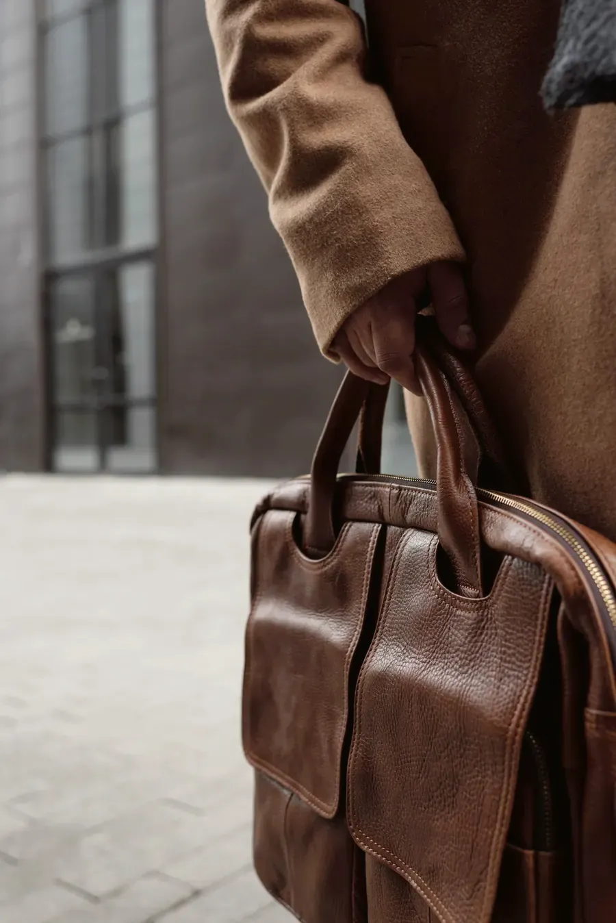 Tan leather carryall held outdoors