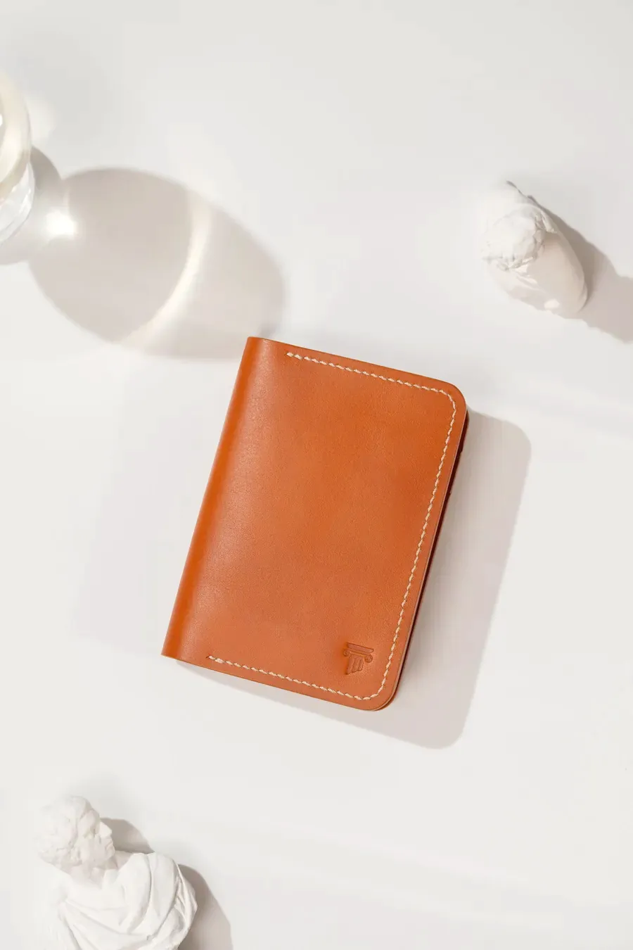 Brown leather wallet on a light surface