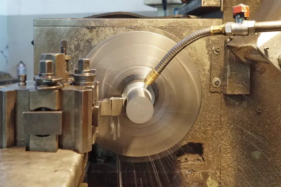 Metal lathe with coolant running over a part
