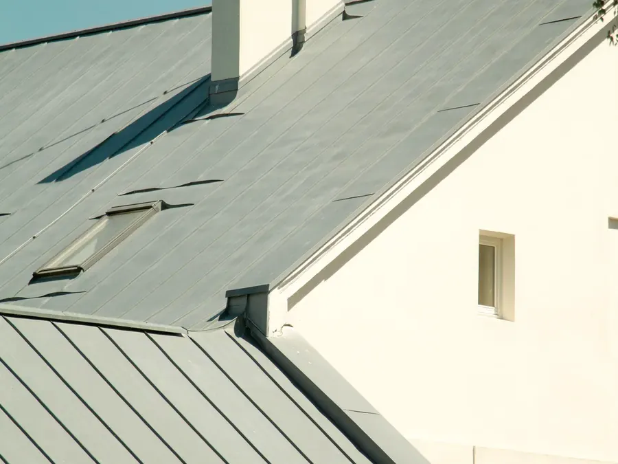 Standing-seam metal roof on a stone house