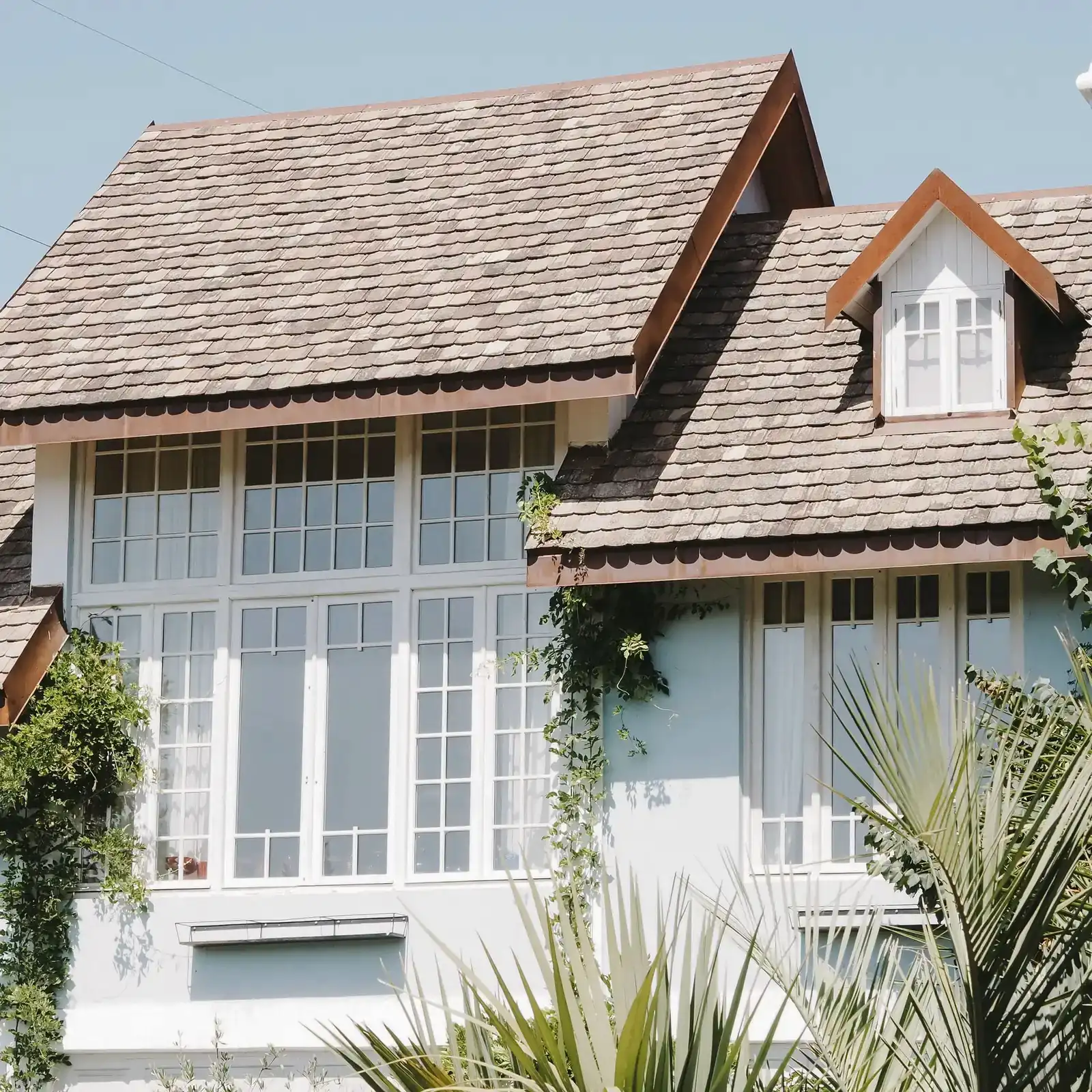 House with a shingled roof and large windows
