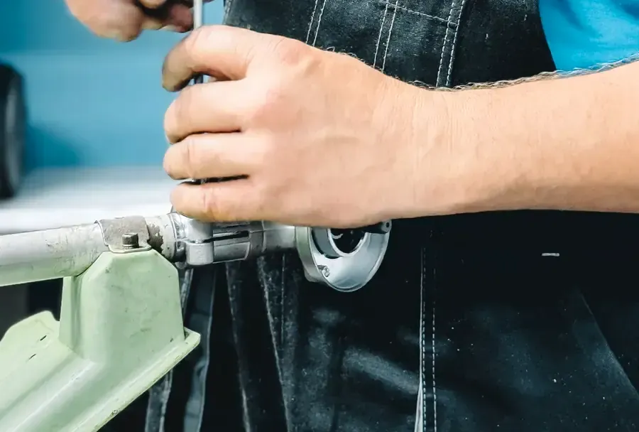 Plumber repairing a pipe with a wrench